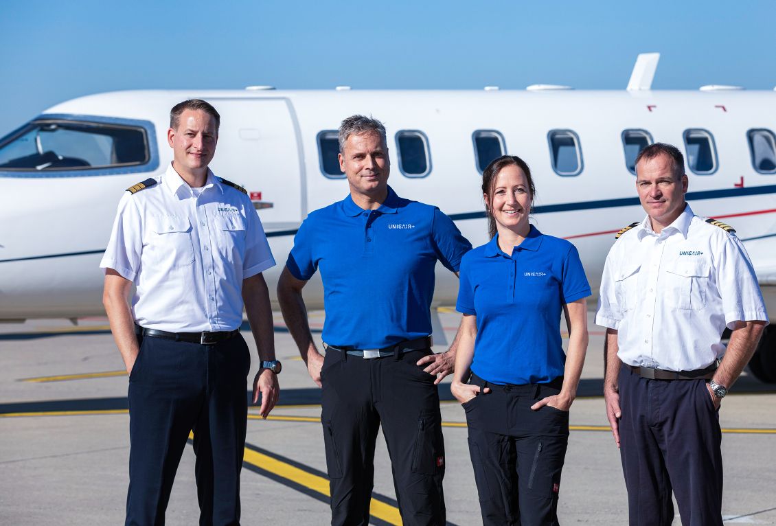 Pilots and medical personal in front of an air ambulance jet